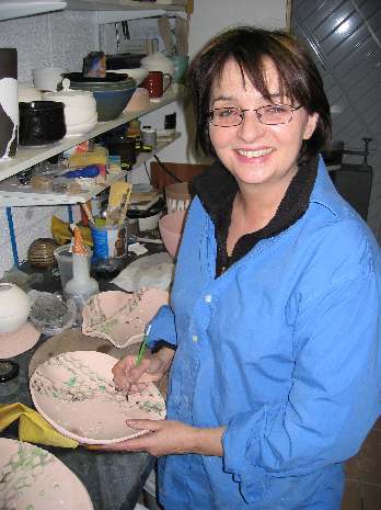 Denise Lonsdale decorating a bowl